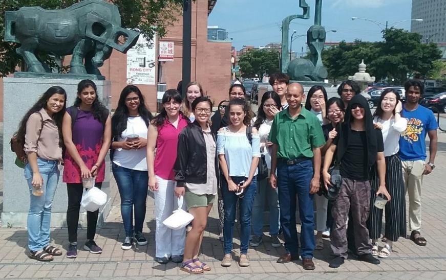 Members of the Bhushan lab standing together outdoors